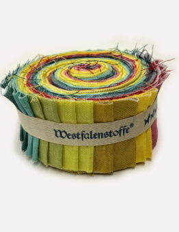 Rolled coil of colorful fabric strips with frayed edges in green, yellow, red, and blue hues.
