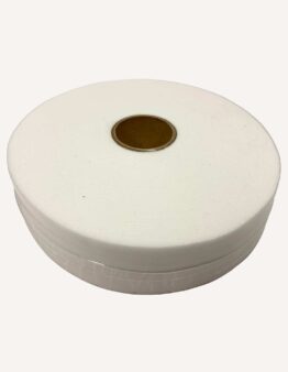 Close-up of a large white spool of thread with a brown center on a pale background, viewed from the side