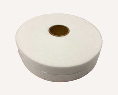 Close-up of a large white spool of thread with a brown center on a pale background, viewed from the side