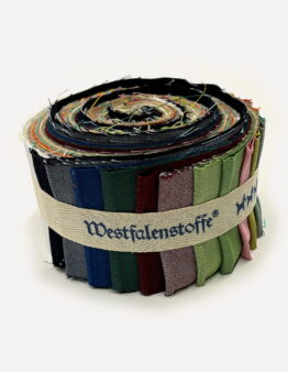 Rolled bundle of colorful fabric swatches bound with a beige strap.