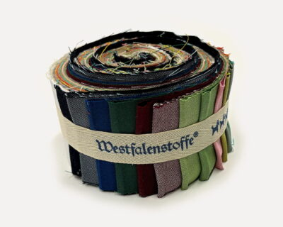 Rolled bundle of colorful fabric swatches bound with a beige strap.