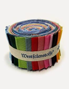 Rolled fabric swatches in rainbow colors bound by a beige strap; frayed edges visible (text on strap reads Westfalenstoff).