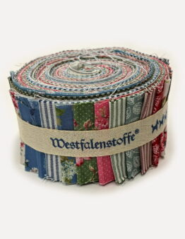 Rolled bundle of colorful fabric strips bound with a beige strap, showing various patterns and stitching details.