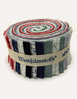 Rolled fabric bundle with multiple sewn strips in blue, red, and green patterns bound by a beige strap.