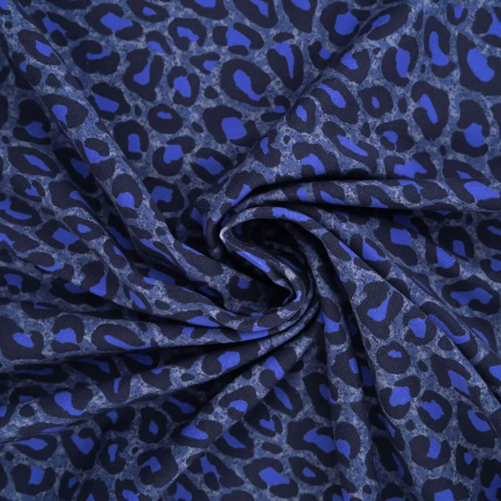 Blue leopard-print fabric twisted into a spiral, showing a dark blue and royal blue pattern.