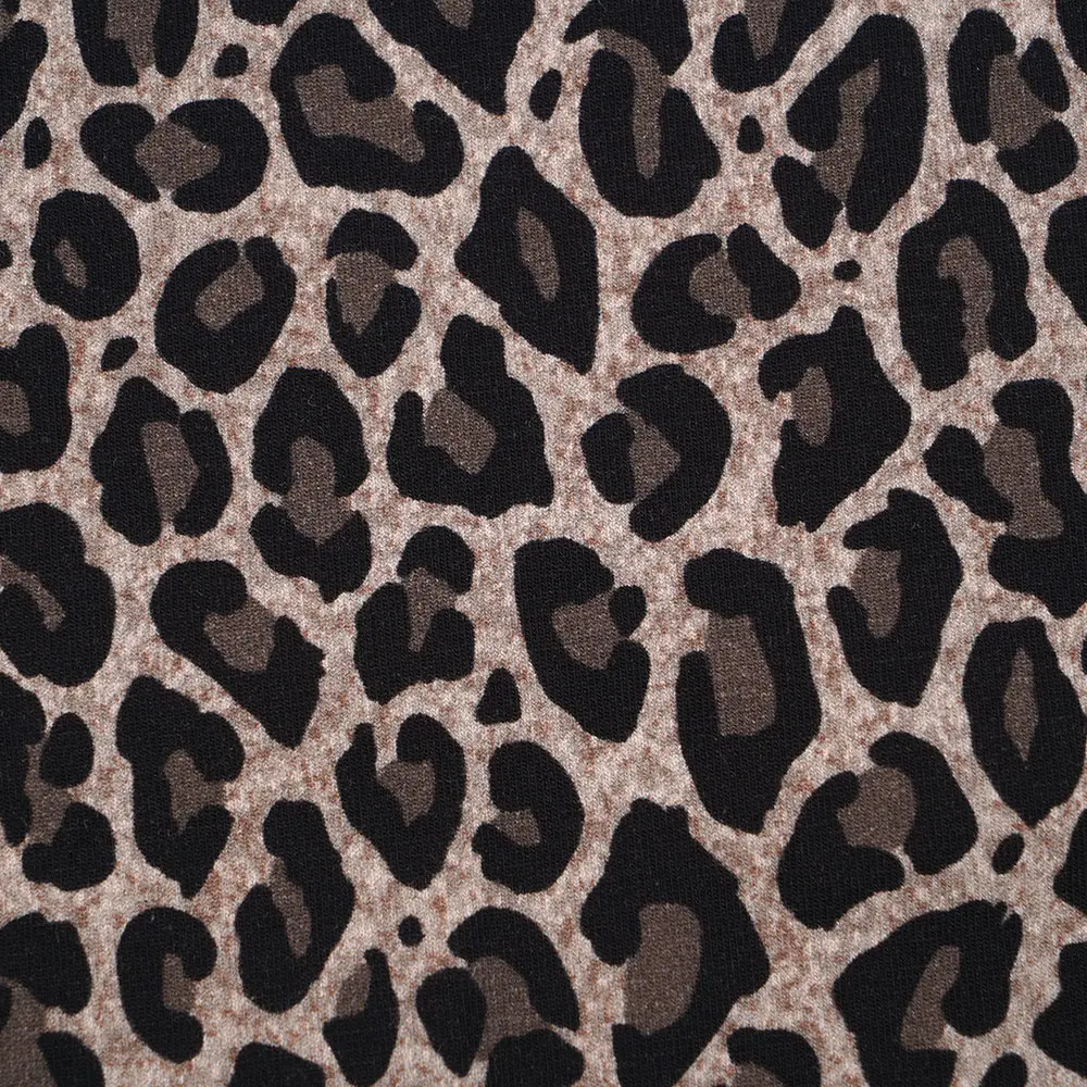 Leopard print fabric pattern with black and dark brown spots on a tan background.