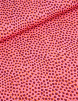 Close-up of bright pink fabric with evenly spaced purple polka dots.