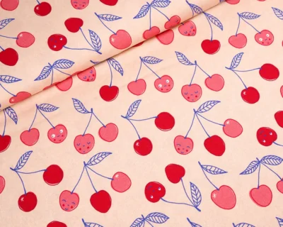 Beige fabric pattern with pink and red cherries and blue leaves scattered across, with gentle fold lines suggesting a draped textile.