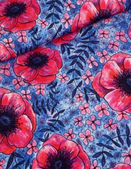 Fabric pattern featuring large red poppies and small pink flowers on a textured blue background with dark leaves.