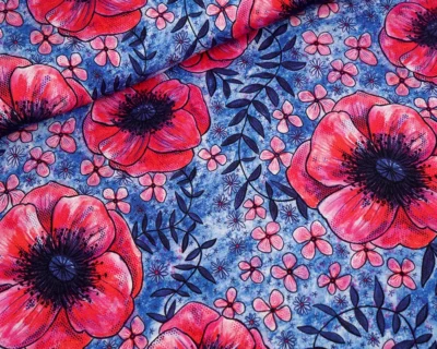Fabric pattern featuring large red poppies and small pink flowers on a textured blue background with dark leaves.