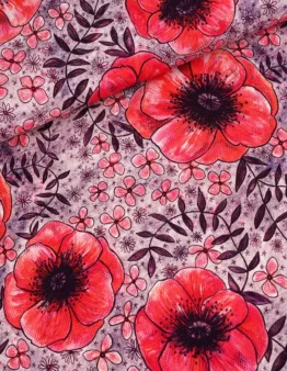Bright red poppies and small pink flowers on a purple patterned fabric surface with dark leaves.”,