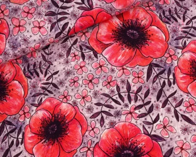 Bright red poppies and small pink flowers on a purple patterned fabric surface with dark leaves.”,