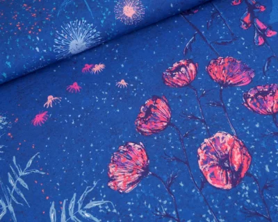 Blue fabric close-up featuring pink blossoms and light blue burst accents on a cobalt background.