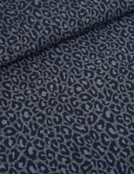 Close-up of dark blue-gray leopard print fabric with a rolled edge at the top-left corner.