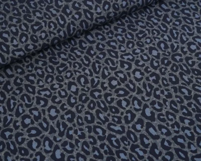 Close-up of dark blue-gray leopard print fabric with a rolled edge at the top-left corner.